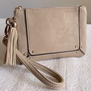 Tan vegan wristlet with tassel and gold studs.